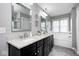 Bright bathroom featuring double sink vanity with granite countertop and dark wood cabinets at 18820 Wychwood Pl, Noblesville, IN 46062