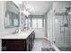 A bathroom featuring a double vanity and enclosed glass shower, designed for comfort at 18820 Wychwood Pl, Noblesville, IN 46062