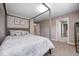 Cozy bedroom featuring a canopy bed, soft carpeting, and views into other rooms at 18820 Wychwood Pl, Noblesville, IN 46062
