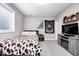 A bedroom with carpeted floors, a bed, a window, and a TV at 18820 Wychwood Pl, Noblesville, IN 46062
