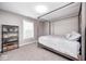 Bright bedroom with a gray canopy bed, complementing shelving, and a sunlit window at 18820 Wychwood Pl, Noblesville, IN 46062