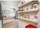 Bright bedroom with neutral tones, a bed, and a decorative floating shelf at 18820 Wychwood Pl, Noblesville, IN 46062