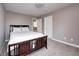 Comfortable bedroom with a dark wood bed frame and soft, neutral carpeting at 18820 Wychwood Pl, Noblesville, IN 46062