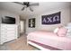 Well-lit bedroom with a bed, dresser, and closet space at 18820 Wychwood Pl, Noblesville, IN 46062