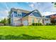Charming two-story brick home featuring a spacious lawn and two-car garage at 18820 Wychwood Pl, Noblesville, IN 46062