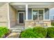Charming front porch with brick accents, a cozy bench, and well-maintained landscaping for inviting curb appeal at 18820 Wychwood Pl, Noblesville, IN 46062