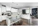 Bright kitchen with granite countertops, white cabinetry, a center island with seating, and stainless steel appliances at 18820 Wychwood Pl, Noblesville, IN 46062