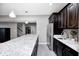 A kitchen with dark cabinets, granite countertops, and stainless steel appliances at 18820 Wychwood Pl, Noblesville, IN 46062