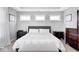 A serene bedroom with neutral tones features three windows and matching bedside tables at 18820 Wychwood Pl, Noblesville, IN 46062