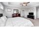 A main bedroom with tray ceilings, ceiling fan and an ensuite bathroom at 18820 Wychwood Pl, Noblesville, IN 46062