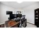 An office with a large wooden desk provides ample space for work, complete with shelving and lighting at 18820 Wychwood Pl, Noblesville, IN 46062