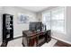 A dedicated home office with an ornate desk and artwork, offering a productive and stylish workspace at 18820 Wychwood Pl, Noblesville, IN 46062