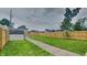 Large fenced backyard with lush grass, a shed, and ample space for outdoor activities at 1918 Cornell Ave, Indianapolis, IN 46202