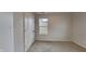 Well-lit bedroom with neutral walls, carpet flooring and a window overlooking the exterior at 1918 Cornell Ave, Indianapolis, IN 46202