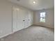 Clean bedroom with a closet, carpet, and a bright window at 1918 Cornell Ave, Indianapolis, IN 46202
