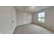 Bedroom featuring neutral tones, plush carpet, closet, and a sunlit window at 1918 Cornell Ave, Indianapolis, IN 46202
