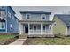 Charming two-story home featuring a cozy front porch, offering a welcoming curb appeal in a residential neighborhood at 1918 Cornell Ave, Indianapolis, IN 46202