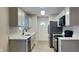 Clean kitchen with plenty of cabinet space, stainless steel appliances, and a large window with lots of natural light at 1918 Cornell Ave, Indianapolis, IN 46202