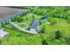 Captivating aerial view of a home featuring a private pond, firepit, mature trees, and manicured landscaping at 1933 S 825 E, Zionsville, IN 46077