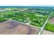 High-angle aerial shot of country estate with pond and farmland creating a serene, private oasis at 1933 S 825 E, Zionsville, IN 46077