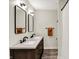 Bathroom features a double sink vanity with modern fixtures and granite countertops with wood-look flooring at 1933 S 825 E, Zionsville, IN 46077