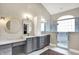 Elegant bathroom features a dual sink vanity with marble countertops and frameless glass shower at 1933 S 825 E, Zionsville, IN 46077