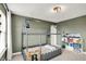 bedroom boasts a modern bed frame, natural lighting, and themed decor on olive green walls at 1933 S 825 E, Zionsville, IN 46077