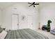 Bright bedroom with high ceilings and fan, neutral walls, and decorative dinosaur bookshelf at 1933 S 825 E, Zionsville, IN 46077