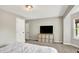 Cozy bedroom with large TV, carpeting, neutral paint, and natural light from a window at 1933 S 825 E, Zionsville, IN 46077