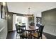 Dining room with dark walls, modern chandelier, dark furniture, and a view of the home's entry at 1933 S 825 E, Zionsville, IN 46077