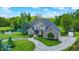 Beautifully landscaped home with a pond, circular driveway, and a detached garage or shed at 1933 S 825 E, Zionsville, IN 46077
