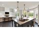 Modern kitchen showcasing the island with granite counters and view to the living area at 1933 S 825 E, Zionsville, IN 46077