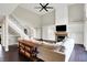 Open-concept living room featuring a fireplace, staircase, and comfortable seating arrangement at 1933 S 825 E, Zionsville, IN 46077