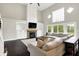 Bright living room with stone fireplace, soaring ceilings, and a large sectional sofa at 1933 S 825 E, Zionsville, IN 46077