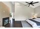 Spacious main bedroom with vaulted ceilings, fireplace, dark hardwood floors and neutral tones at 1933 S 825 E, Zionsville, IN 46077