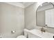 Neutral powder room featuring modern fixtures, an arched mirror, and a white vanity at 1933 S 825 E, Zionsville, IN 46077