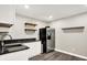 Wet bar area features sleek countertops, modern cabinetry, and a stainless steel refrigerator at 1933 S 825 E, Zionsville, IN 46077