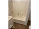 Bright bathroom with a standard white shower-tub combination and laminate flooring at 2202 E Brookside Ave, Indianapolis, IN 46218