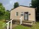 Charming single story home with tan siding and well-maintained front yard at 2202 E Brookside Ave, Indianapolis, IN 46218