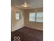 Living room area with multiple windows offering natural light and a modern ceiling fan at 2202 E Brookside Ave, Indianapolis, IN 46218