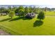 Aerial view of a brick home on sprawling green lot with mature trees and a matching detached garage at 2221 W County Road 500 N, Danville, IN 46122