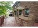 Cozy backyard deck with a wrought-iron table set and mature trees around the edge of property at 2221 W County Road 500 N, Danville, IN 46122
