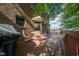 A stained backyard deck features wrought-iron table set and a grill with a view of a brick home at 2221 W County Road 500 N, Danville, IN 46122