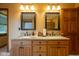 Bathroom featuring a double sink vanity with granite countertops, framed mirrors, and wooden cabinets at 2221 W County Road 500 N, Danville, IN 46122