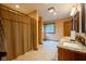 Bathroom featuring double sinks, tile floors, and a shower with curtain at 2221 W County Road 500 N, Danville, IN 46122