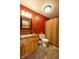 Bathroom features a stone tile floor, wood cabinets, framed mirror, and a shower with a striped curtain at 2221 W County Road 500 N, Danville, IN 46122