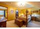 Bedroom features a four-poster bed, wood furniture, plush carpeting, and neutral-colored bedding at 2221 W County Road 500 N, Danville, IN 46122