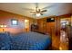 Bedroom with hardwood floors, ceiling fan, en suite bathroom, and ample closet space at 2221 W County Road 500 N, Danville, IN 46122