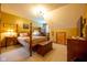 Bedroom boasts a four-poster bed, wood furniture, plush carpeting, and neutral-colored bedding at 2221 W County Road 500 N, Danville, IN 46122