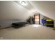 Bonus room features neutral walls, plush carpeting, a TV, and ample space for entertaining at 2221 W County Road 500 N, Danville, IN 46122